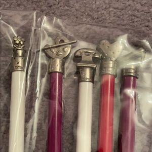 5 pencils topped with silver pencil charms